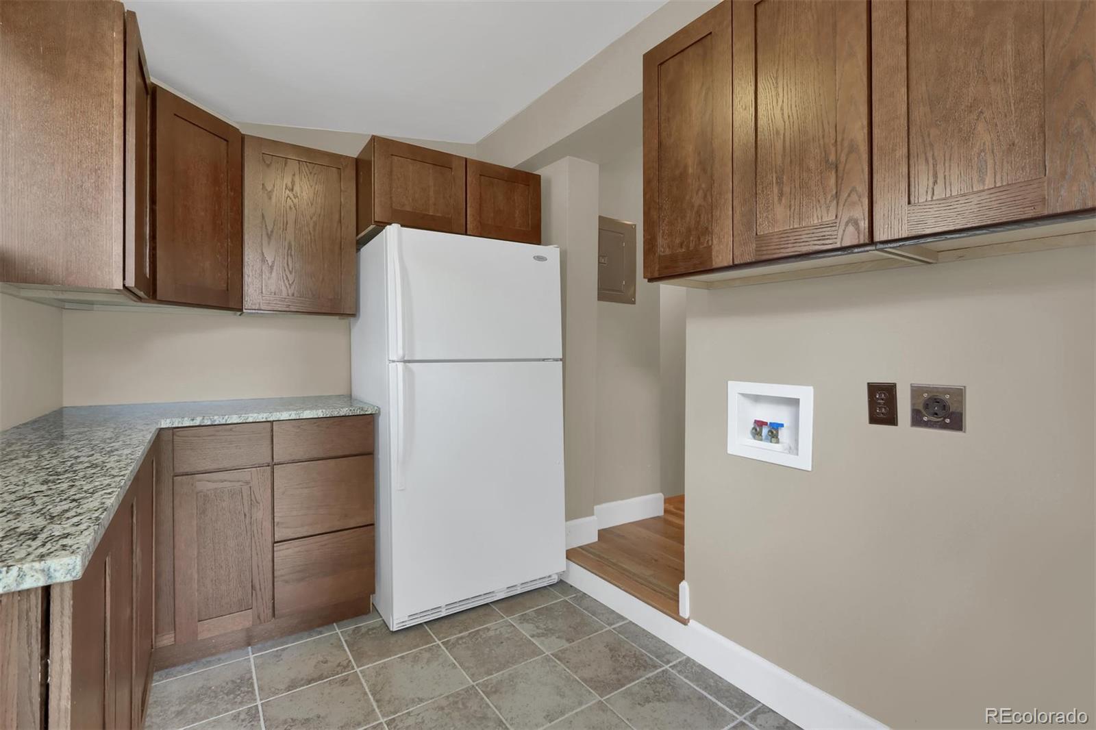 3045 Hay Creek Road Colorado Springs, CO 80921 - Photo 33 of 40 a kitchen with a refrigerator and a sink