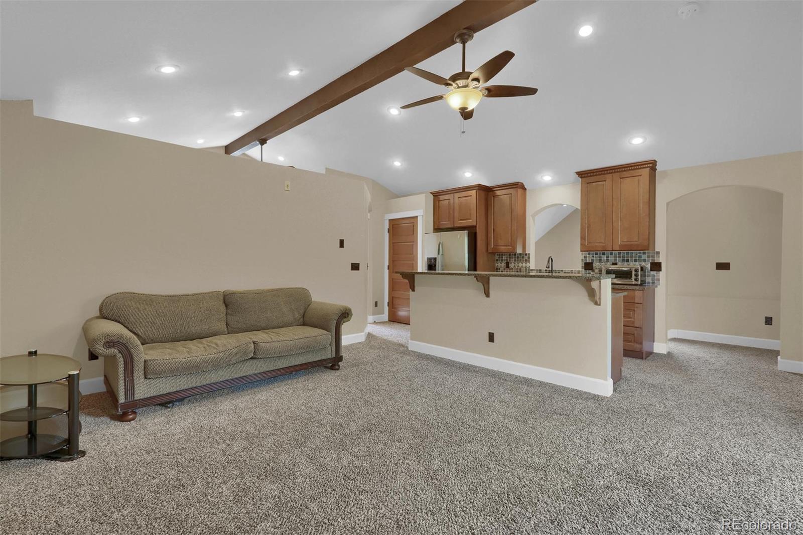 3045 Hay Creek Road Colorado Springs, CO 80921 - Photo 34 of 40 a living room with furniture and kitchen view