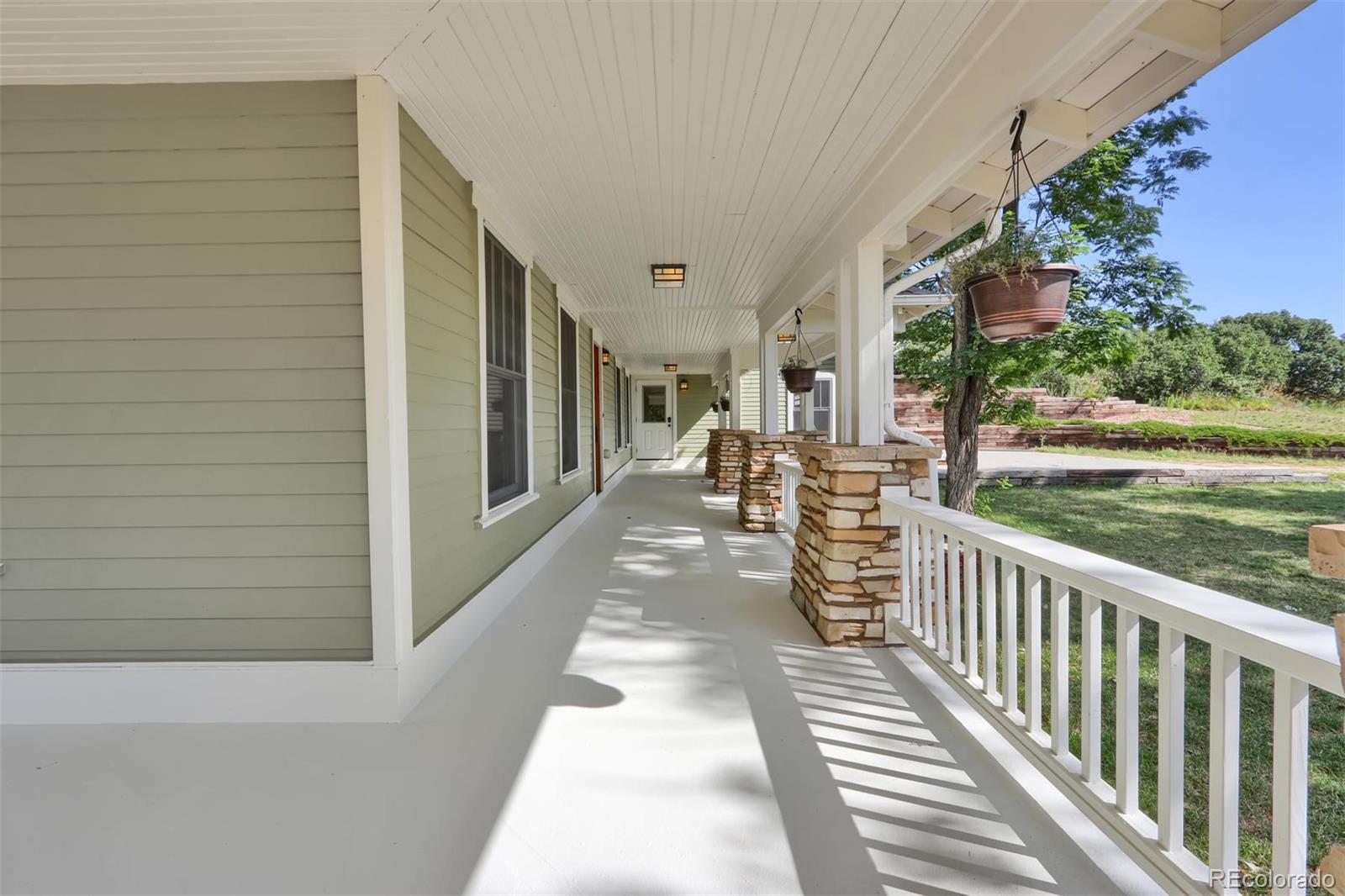 3045 Hay Creek Road Colorado Springs, CO 80921 - Photo 7 of 40 a view of a porch with wooden floor and floor to ceiling window