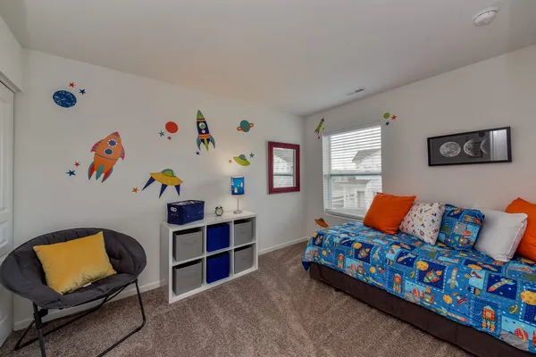 a bedroom with furniture and a wooden floor