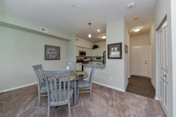 a dining room with furniture and window