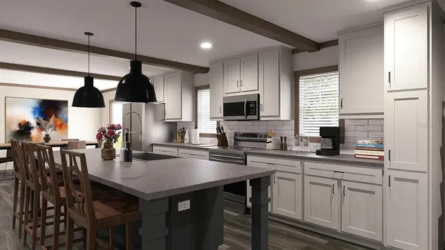 a kitchen with granite countertop a sink a center island and cabinets