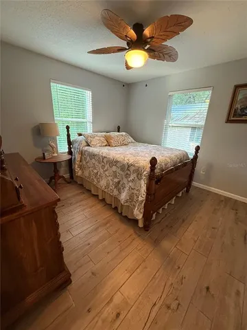 a bedroom with a bed dresser and a window