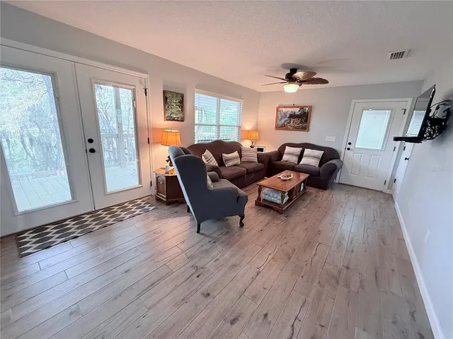 a living room with furniture and a wooden floor