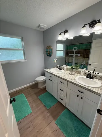 a bathroom with a double vanity sink and mirror