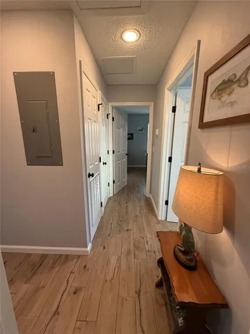 a view of a hallway with wooden floor and staircase