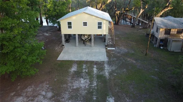 a view of a backyard with table and chairs