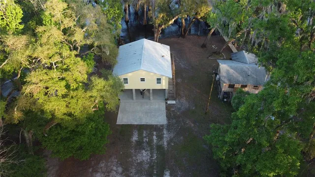 an aerial view of a house with a yard