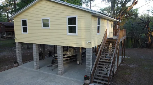 a view of backyard with outdoor seating and plants