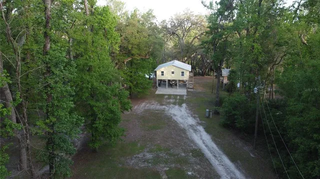 a view of a street with a house in the background