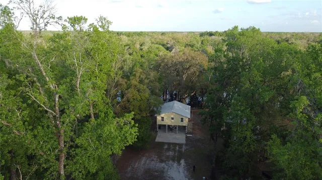 an aerial view of a house with lots of trees