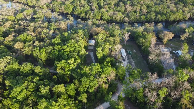 a backyard of a house with lots of green space and trees