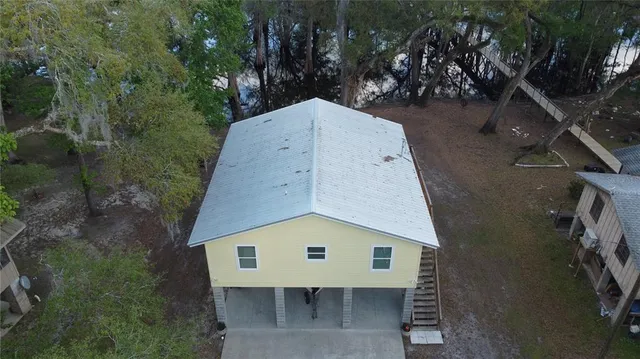 an aerial view of a house with a yard