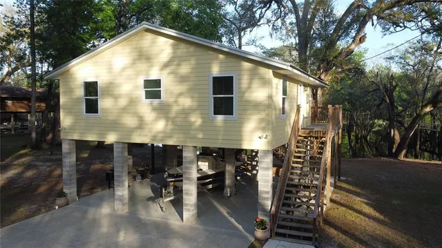 a front view of a house with yard and seating area