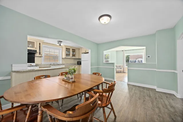 a view of a dining room with furniture and wooden floor