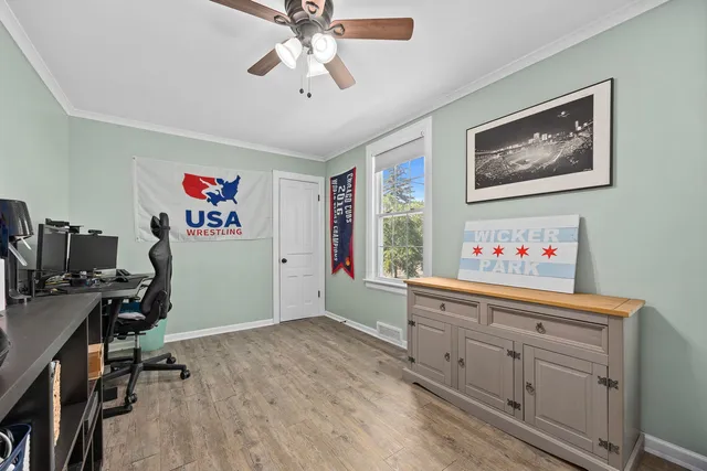 a view of a workspace with furniture and a window