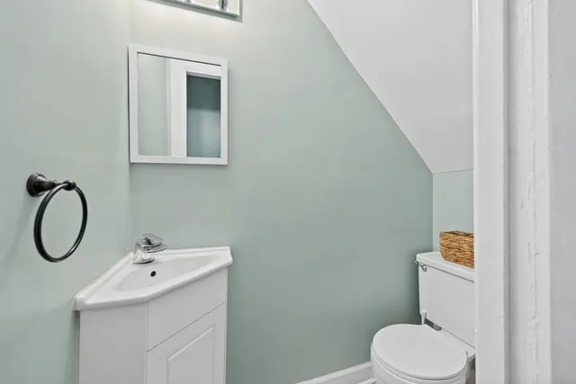 a bathroom with a sink mirror and toilet