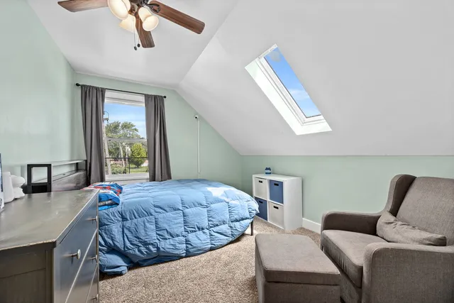 a bedroom with a large bed and a window