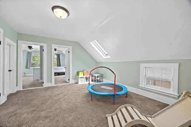 a front view of a house with a garden and yard