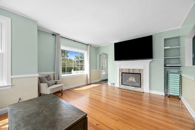 a living room with furniture fireplace and flat screen tv