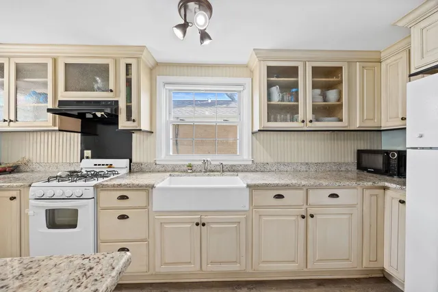a kitchen with stainless steel appliances granite countertop a stove and a sink