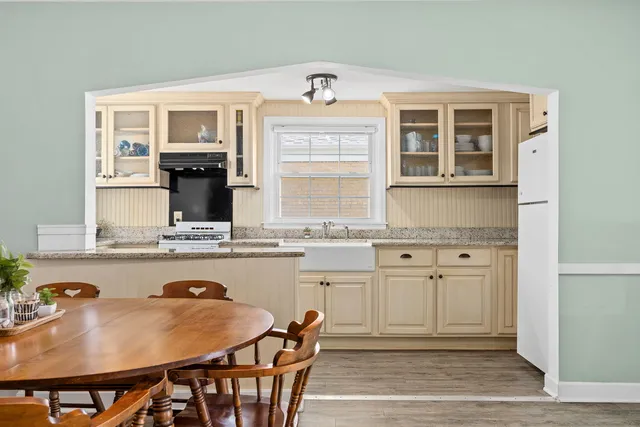 a kitchen with a stove a table and chairs