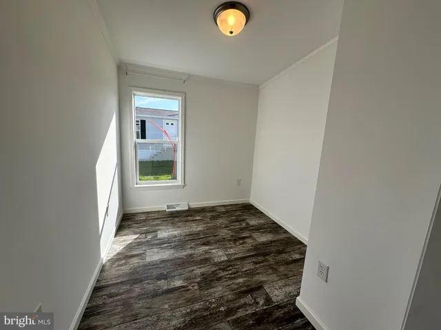 a view of a livingroom with wooden floor and window