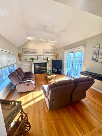 a living room with furniture fireplace and a table