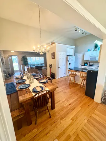 a living room with dining room and wooden floor