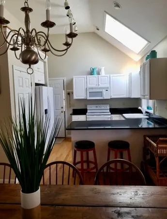 a kitchen with a refrigerator and microwave