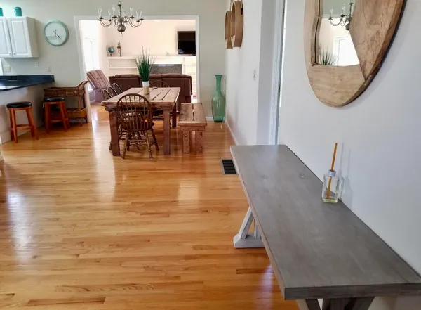 a dining room with furniture and a mirror