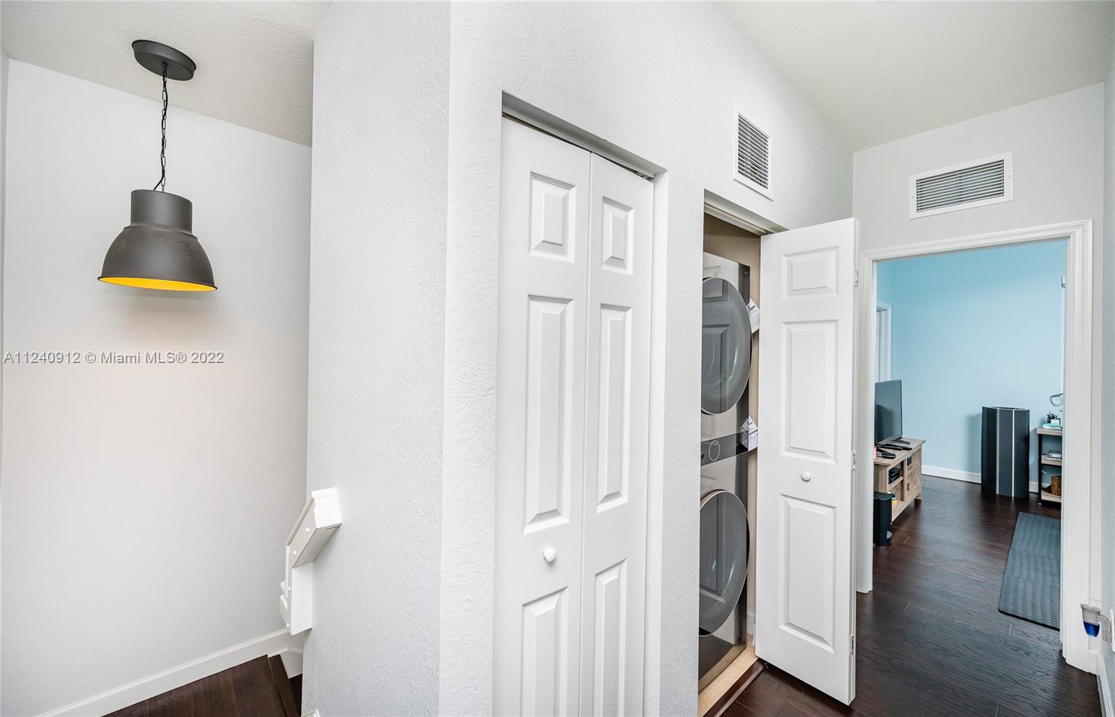 9031 Southwest 227th Street, Unit 9 Cutler Bay, FL 33190 - Photo 11 of 20 a view of a hallway with wooden floor and staircase