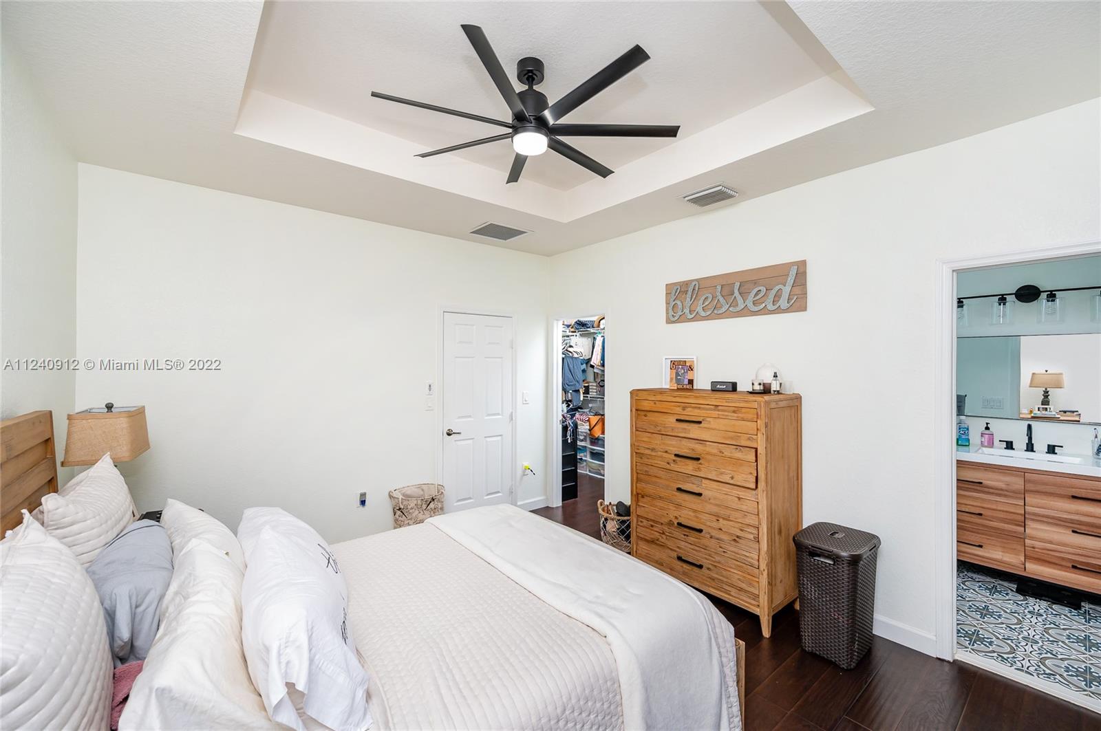 9031 Southwest 227th Street, Unit 9 Cutler Bay, FL 33190 - Photo 12 of 20 a bedroom with a bed and a dresser