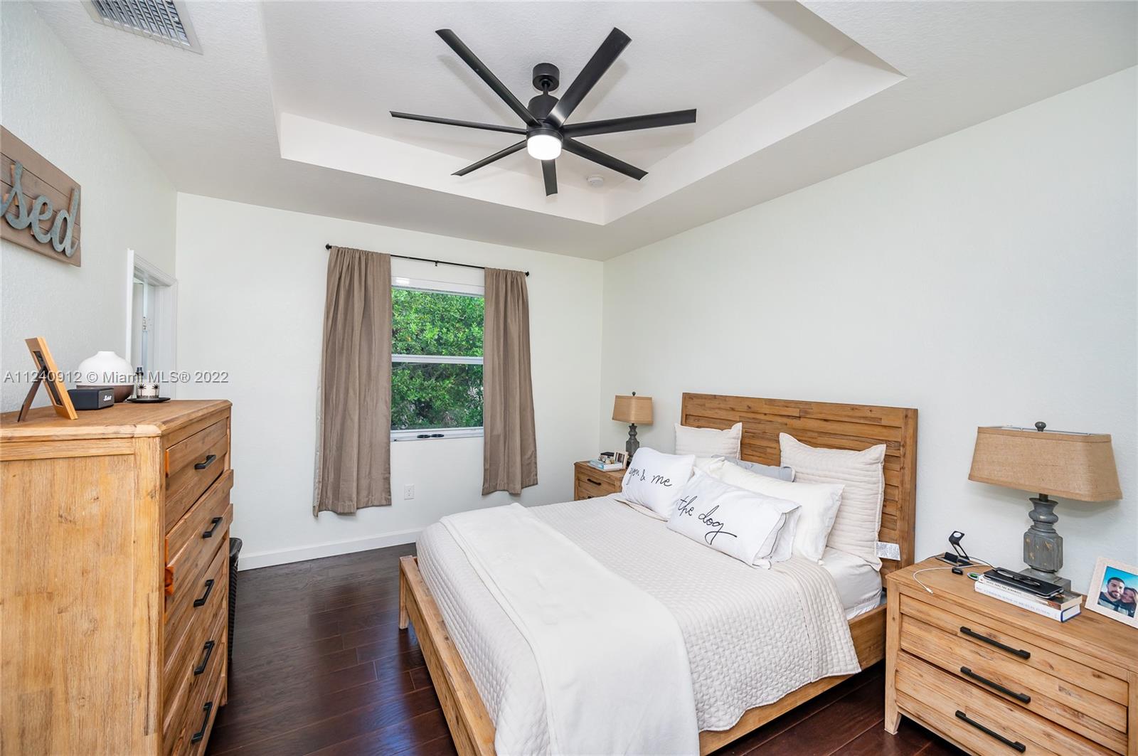 9031 Southwest 227th Street, Unit 9 Cutler Bay, FL 33190 - Photo 13 of 20 a bedroom with a bed and a window