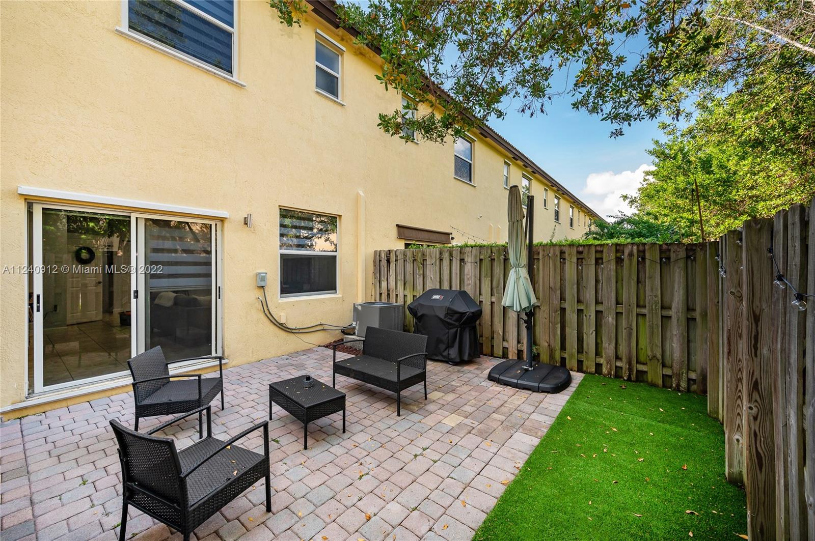 9031 Southwest 227th Street, Unit 9 Cutler Bay, FL 33190 - Photo 19 of 20 a view of a patio with chairs and a table