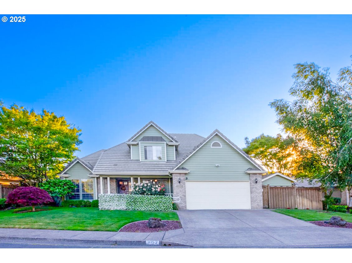 a front view of a house with a garden and yard