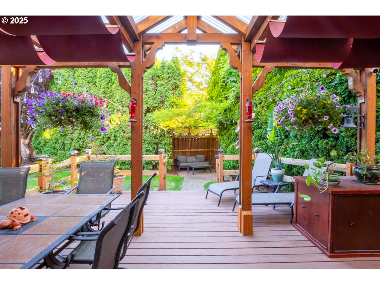3152 Wolf Meadows Lane Eugene, OR 97408 - Photo 21 of 27 a view of a patio with table and chairs potted plants with wooden floor