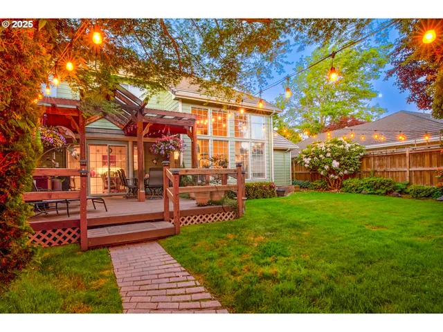 a backyard of a house with table and chairs