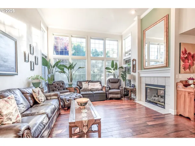 a living room with furniture large window and fireplace