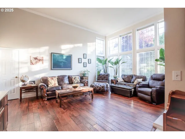 a living room with furniture window and wooden floor