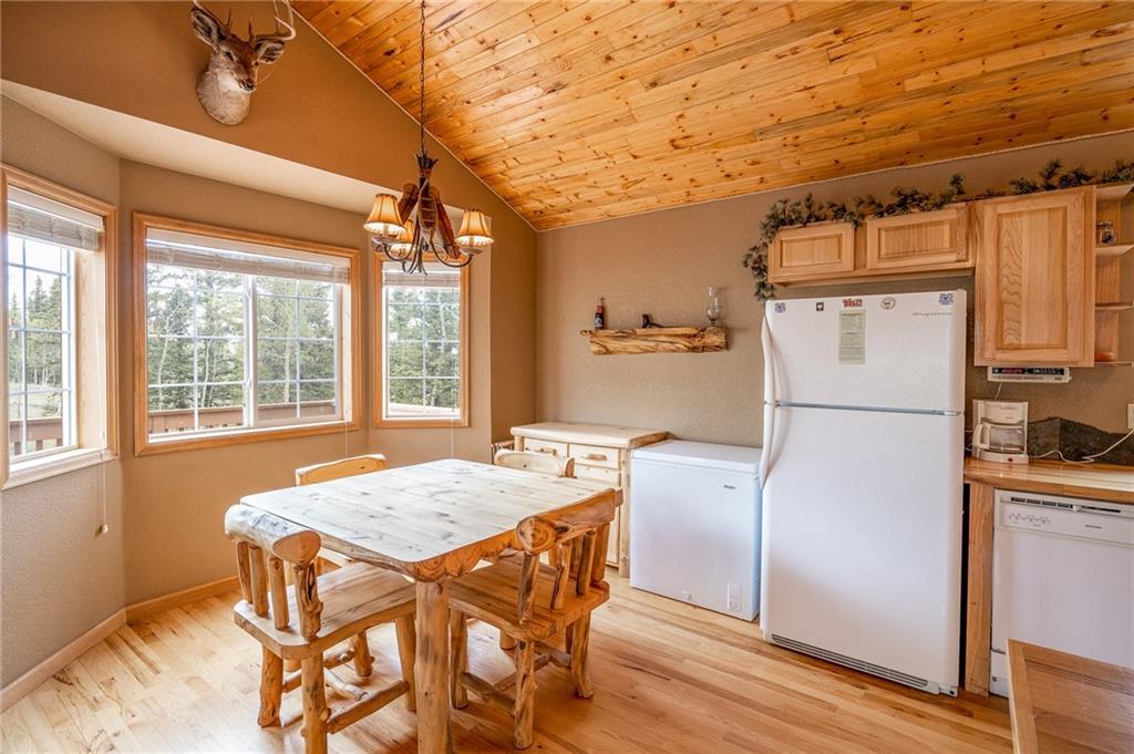 95 Ute Way Como, CO 80432 - Photo 16 of 27 a kitchen with stainless steel appliances granite countertop a refrigerator a sink dishwasher a stove and white countertops with wooden floor