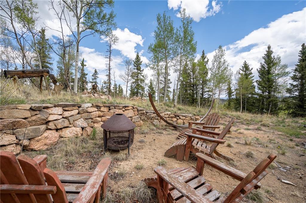 95 Ute Way Como, CO 80432 - Photo 18 of 27 a view of a wooden chairs and fire pit