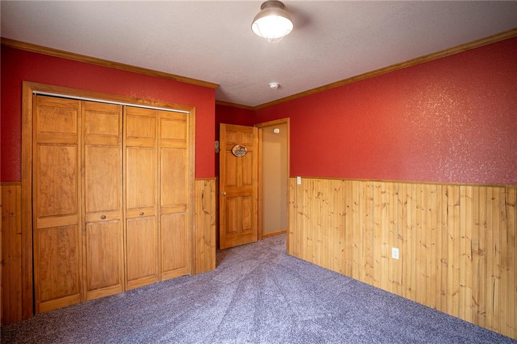 95 Ute Way Como, CO 80432 - Photo 9 of 27 a view of a livingroom with a wooden wall and a window