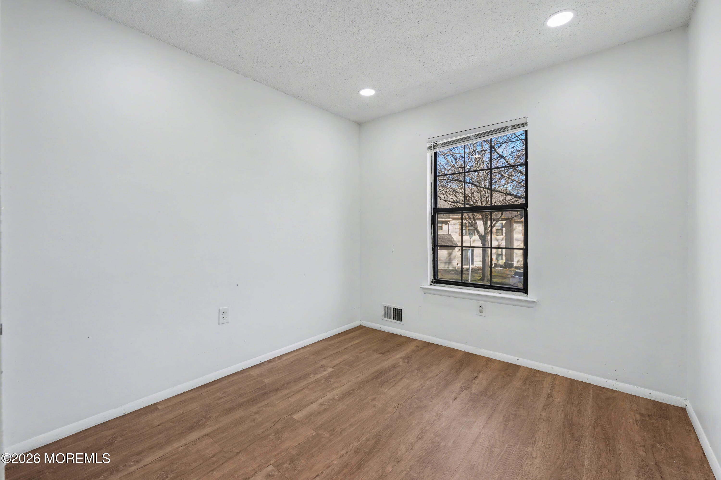 1807 Lilly Lane Jackson, NJ 08527 - Photo 14 of 31 an empty room with wooden floor and windows