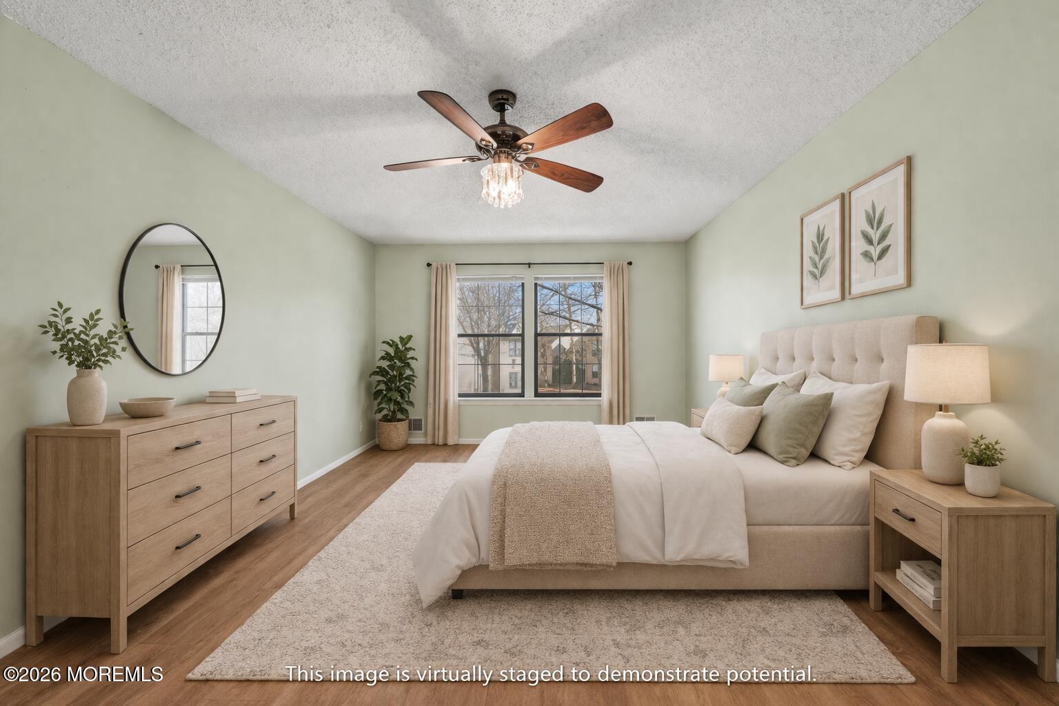 1807 Lilly Lane Jackson, NJ 08527 - Photo 15 of 31 a bedroom with a large bed and a chandelier
