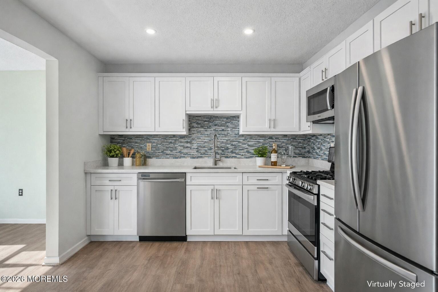 1807 Lilly Lane Jackson, NJ 08527 - Photo 8 of 31 a kitchen with white cabinets stainless steel appliances and a counter space
