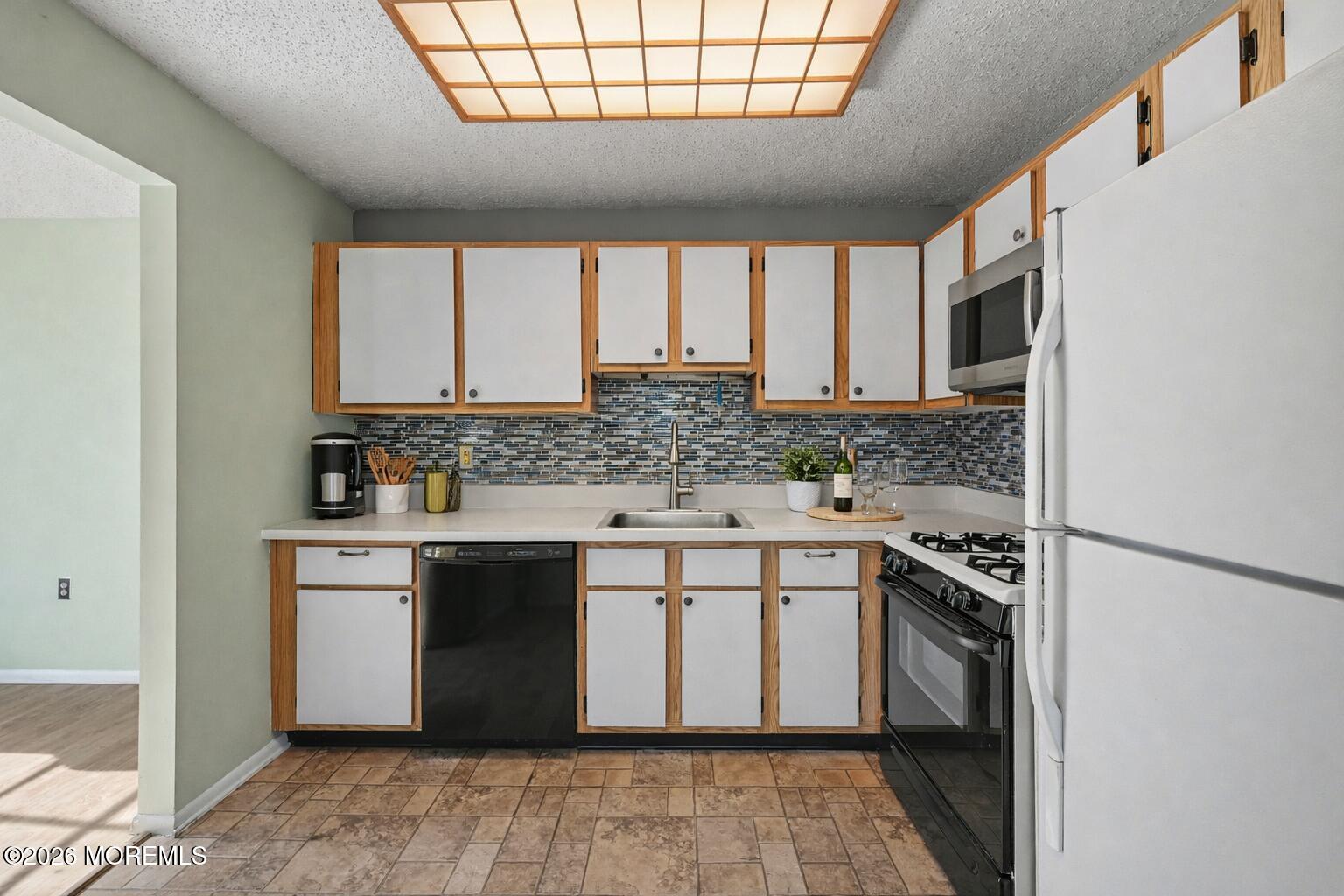 1807 Lilly Lane Jackson, NJ 08527 - Photo 9 of 31 a kitchen with stainless steel appliances granite countertop a stove a sink and a microwave
