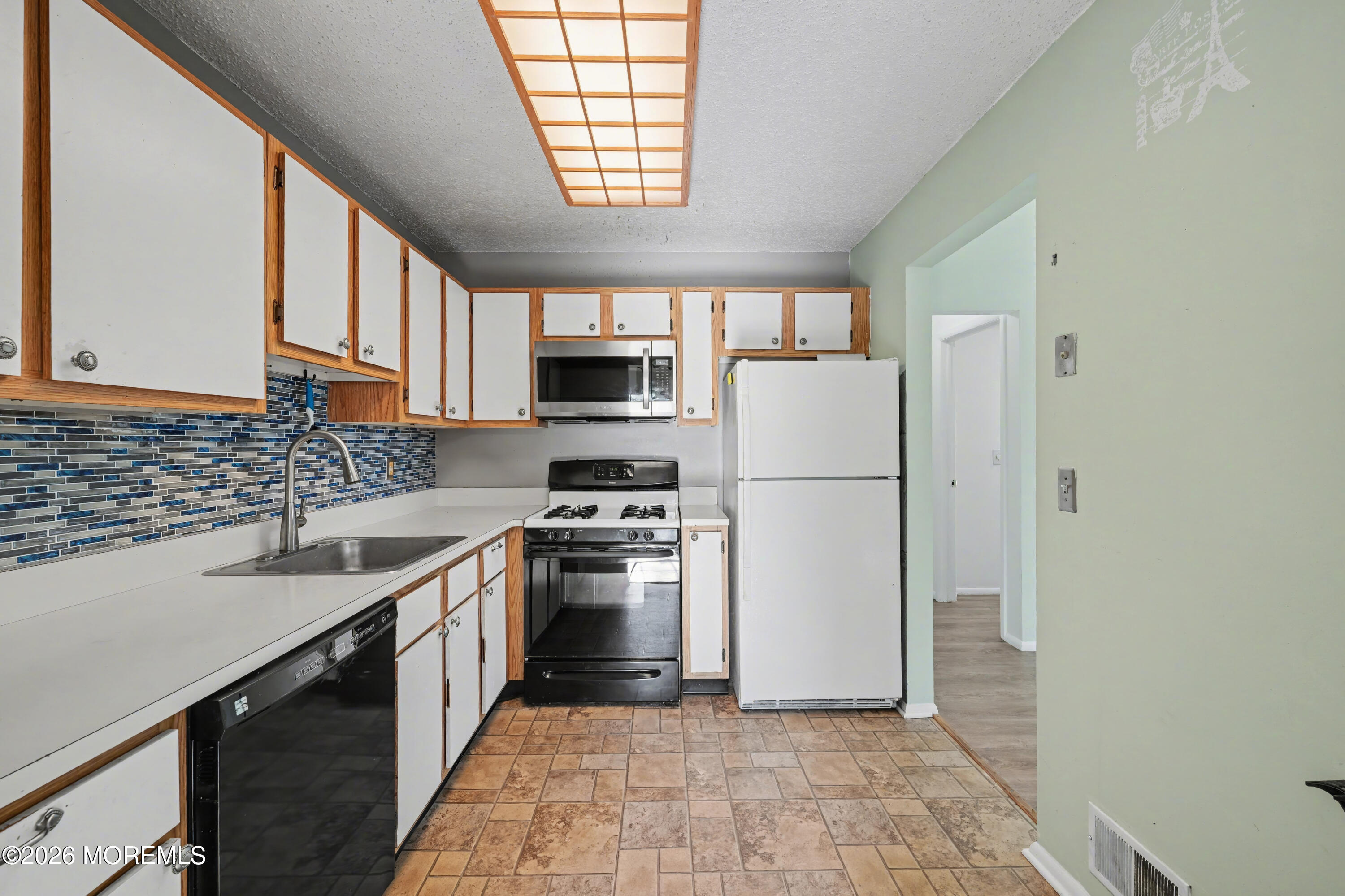 1807 Lilly Lane Jackson, NJ 08527 - Photo 10 of 31 a kitchen with a sink a refrigerator and a stove