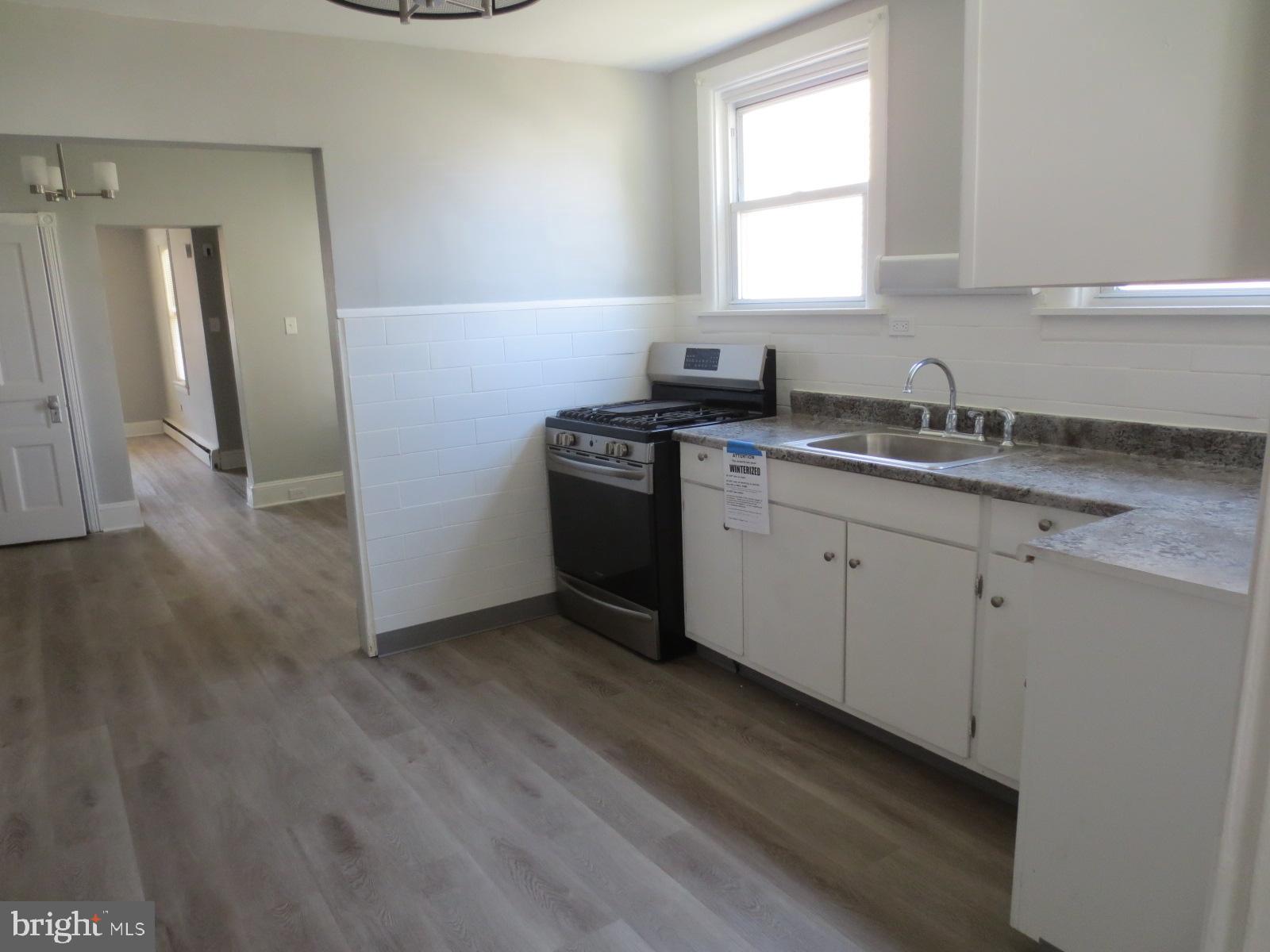 617 Benson Street Philadelphia, PA 19111 - Photo 11 of 37 a kitchen with a sink cabinets appliances and a window