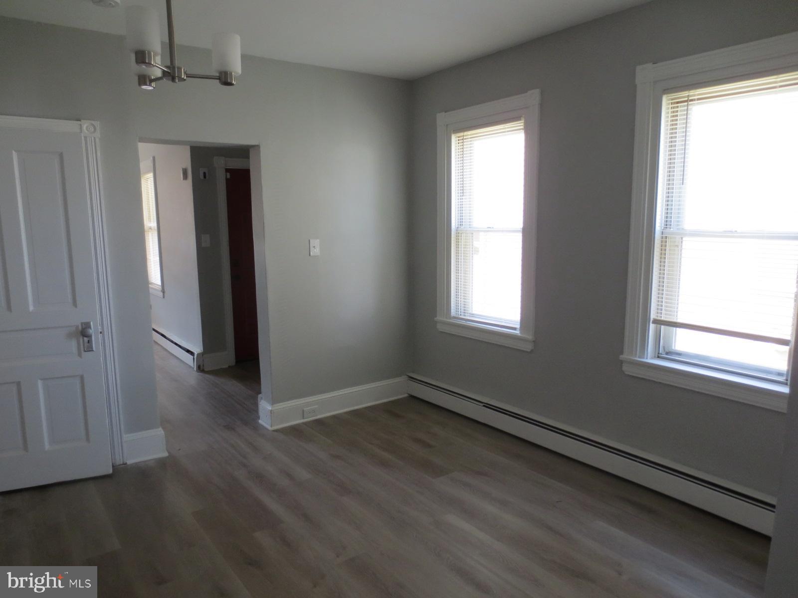 617 Benson Street Philadelphia, PA 19111 - Photo 16 of 37 a view of an empty room with wooden floor and a window